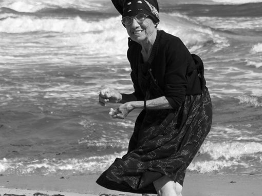 Oude dame op het strand. Sardinië